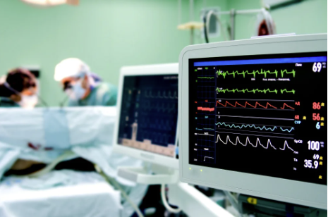 Cardiologist monitors heart rate during cardiac procedure.