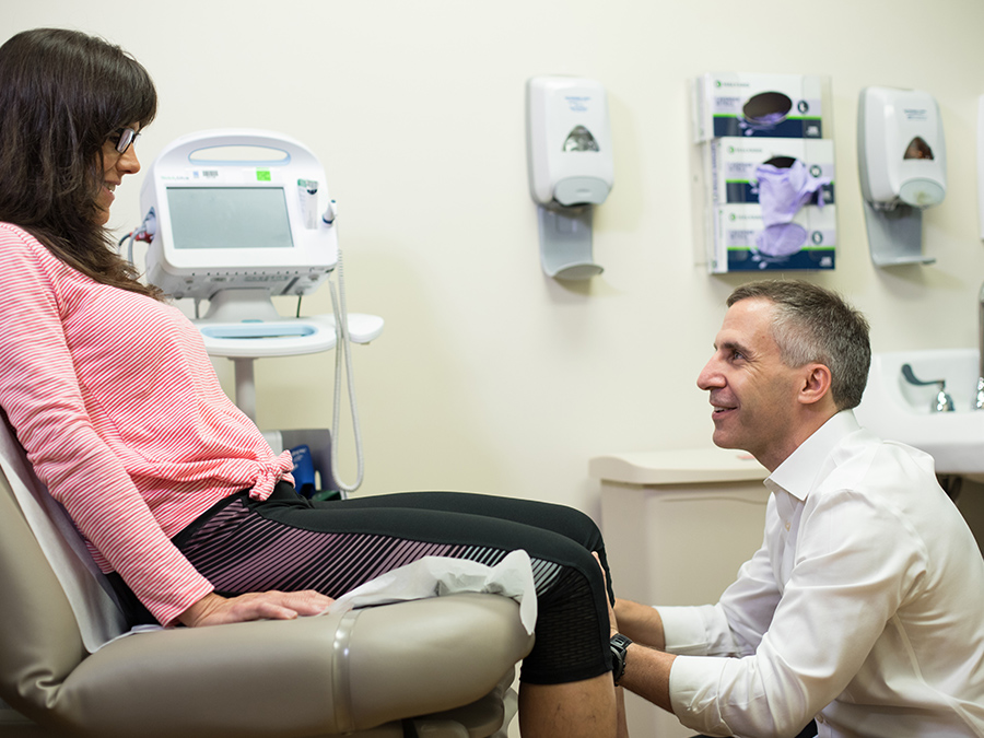 Dr. Eric Martin exams a patient after hip replacement surgery.